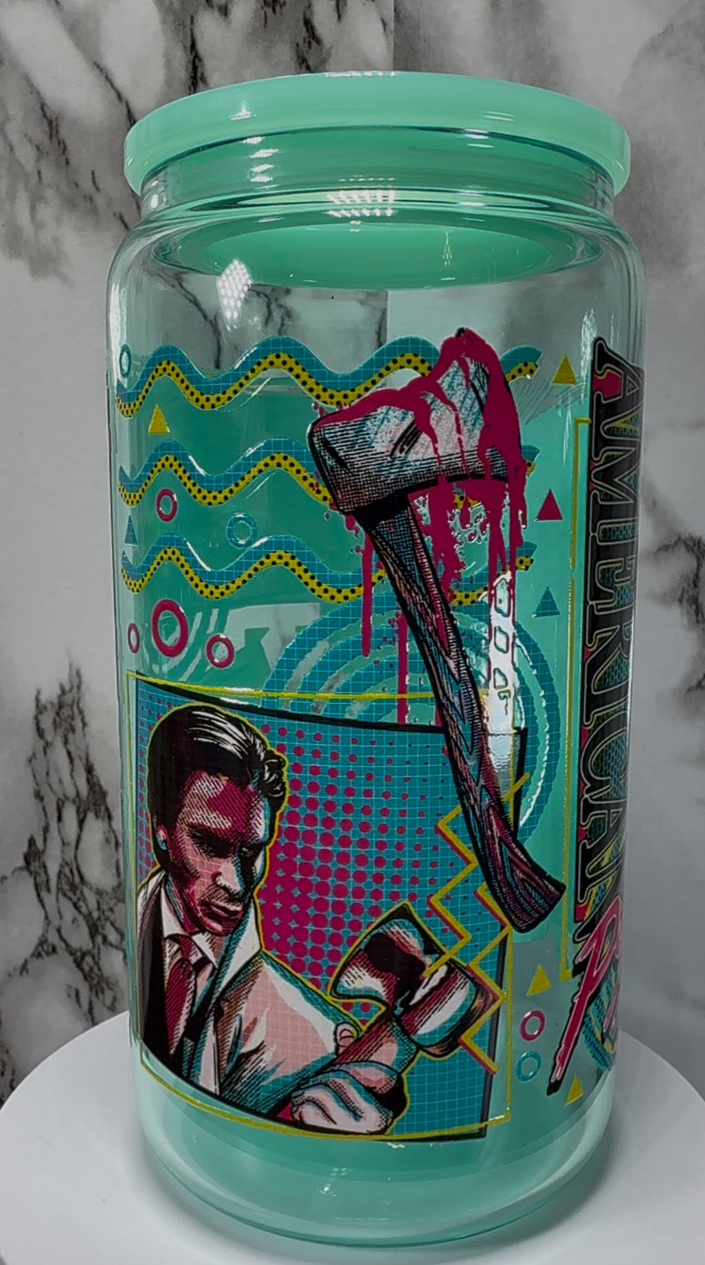 American Psycho Patrick Bateman UVDTF on a teal beer can glass
