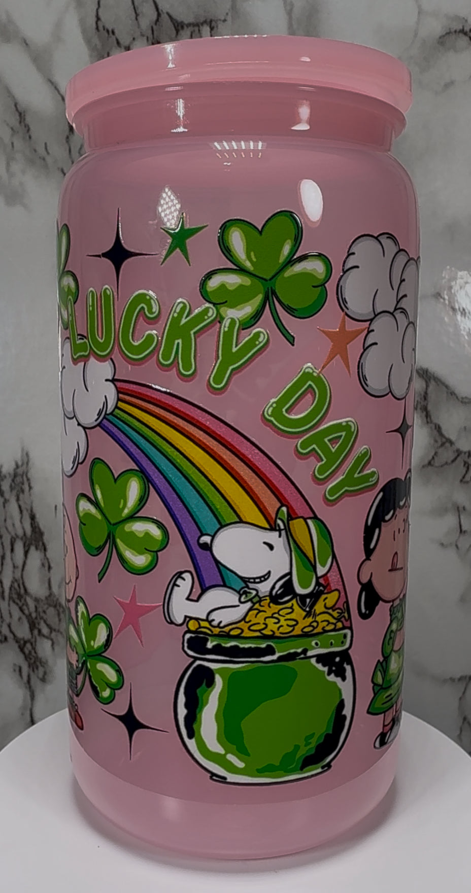 A Charlie Brown St. Patrick’s Day UVDTF on a pink PLASTIC beer can cup