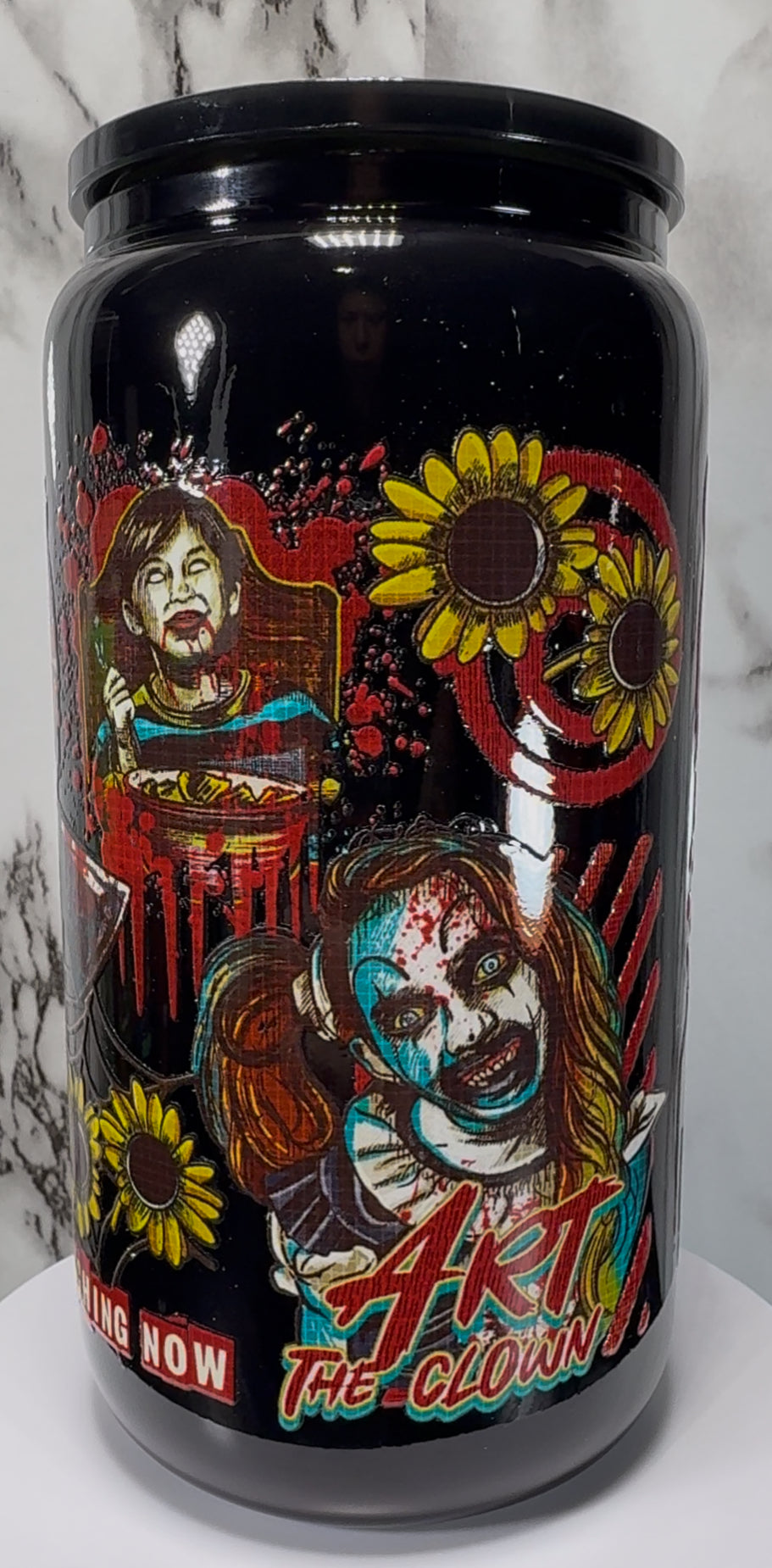 Terrifier Art The Clown UVDTF on a black beer can glass