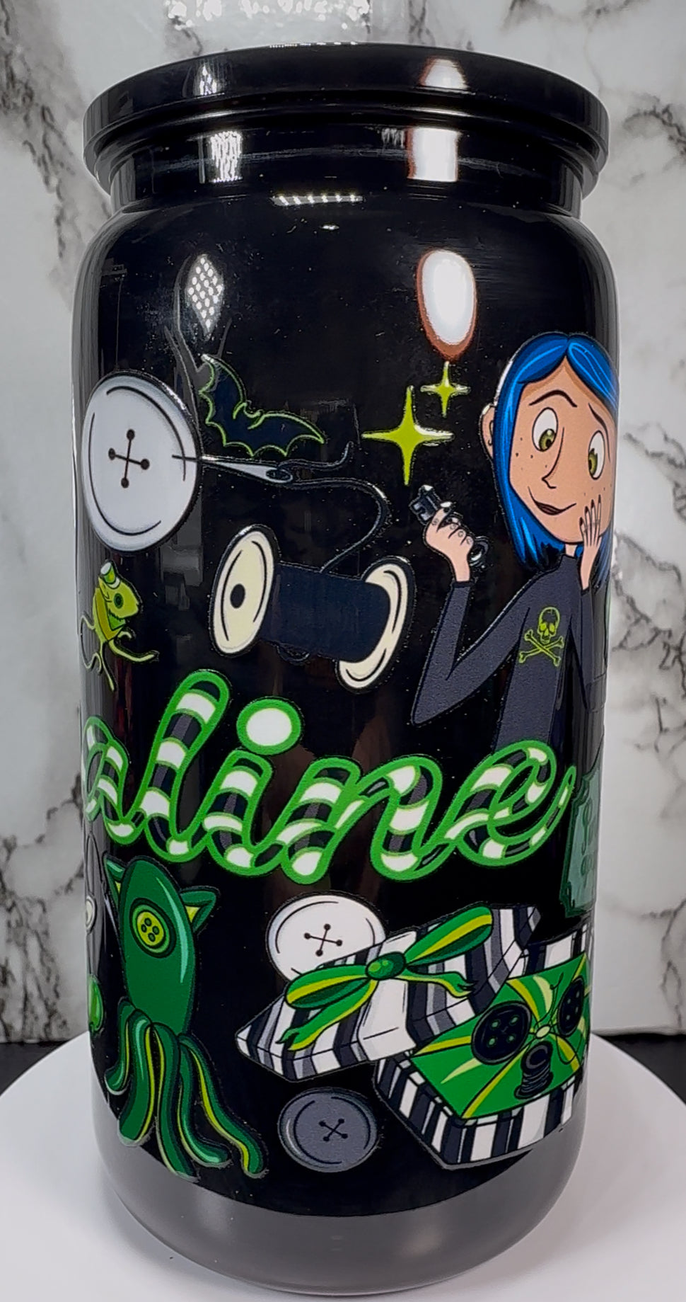Coraline Green UVDTF on a black plastic beer can cup