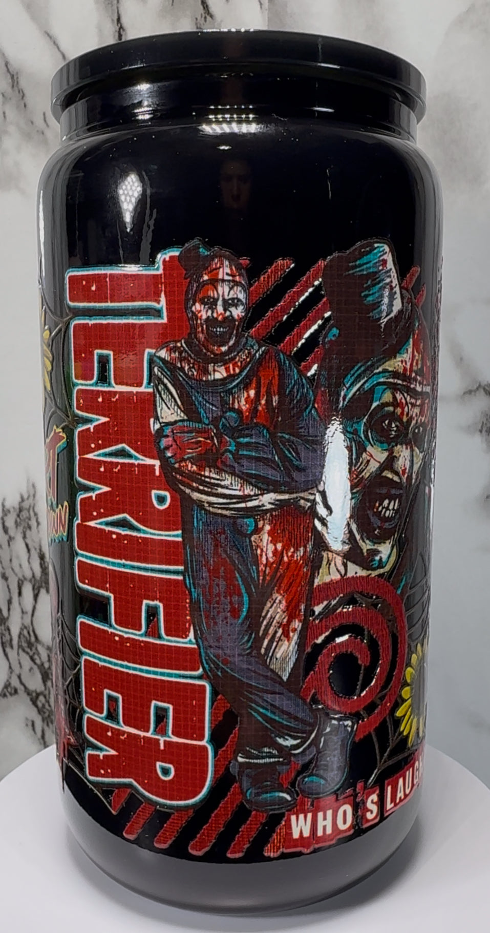 Terrifier Art The Clown UVDTF on a black beer can glass