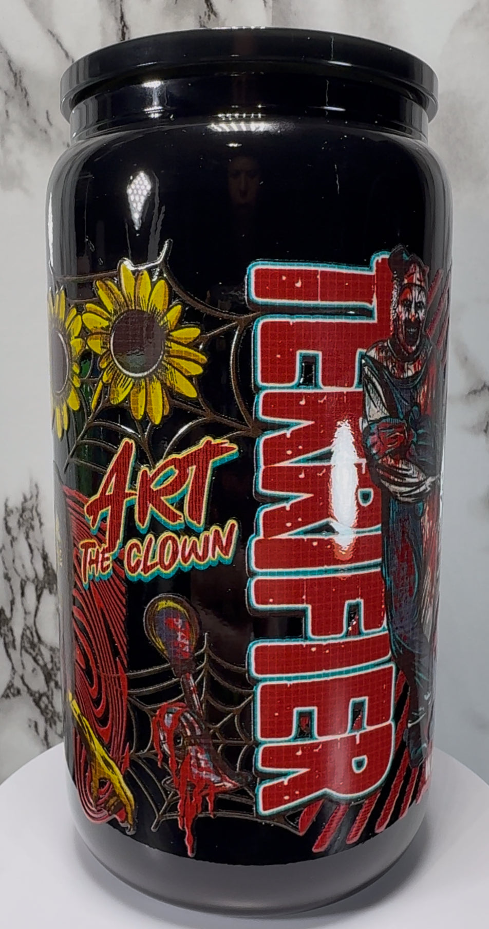 Terrifier Art The Clown UVDTF on a black beer can glass