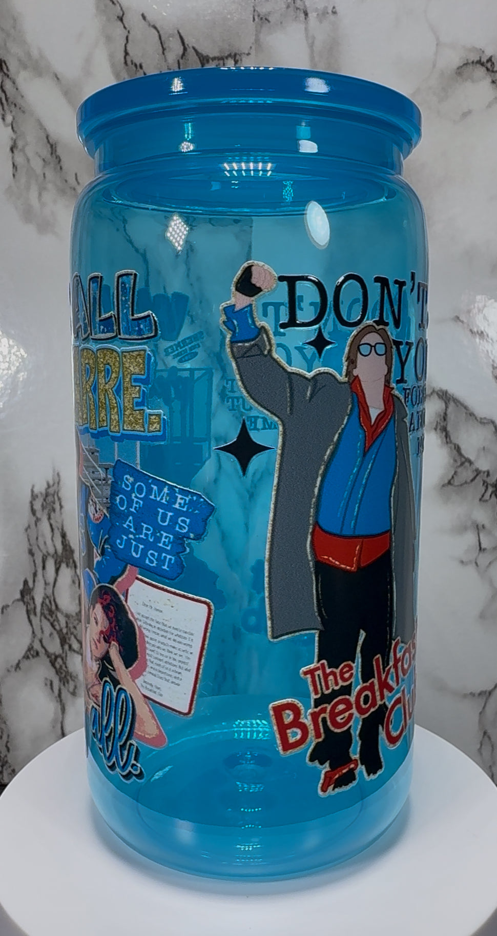 Breakfast Club UVDTF on a bright blue PLASTIC beer can cup