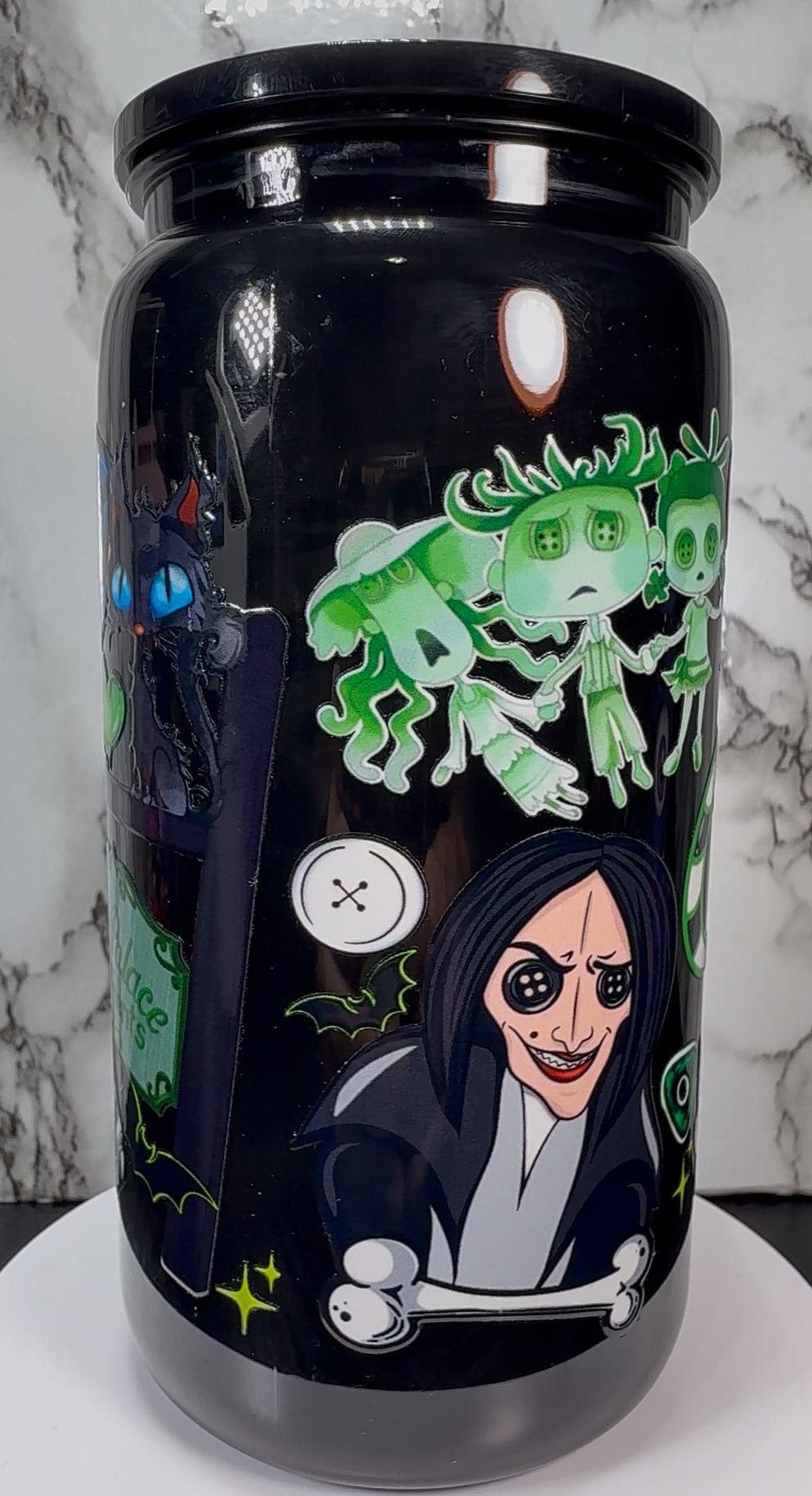 Coraline Green UVDTF on a black plastic beer can cup