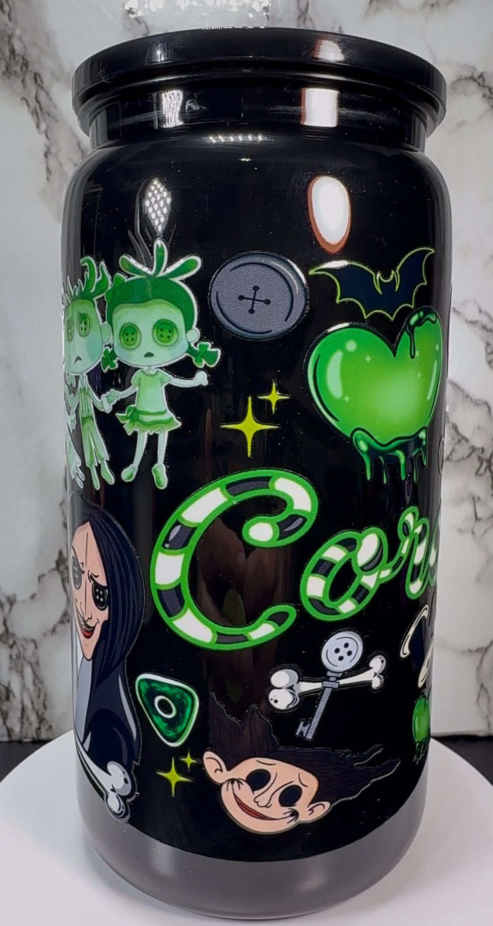Coraline Green UVDTF on a black plastic beer can cup