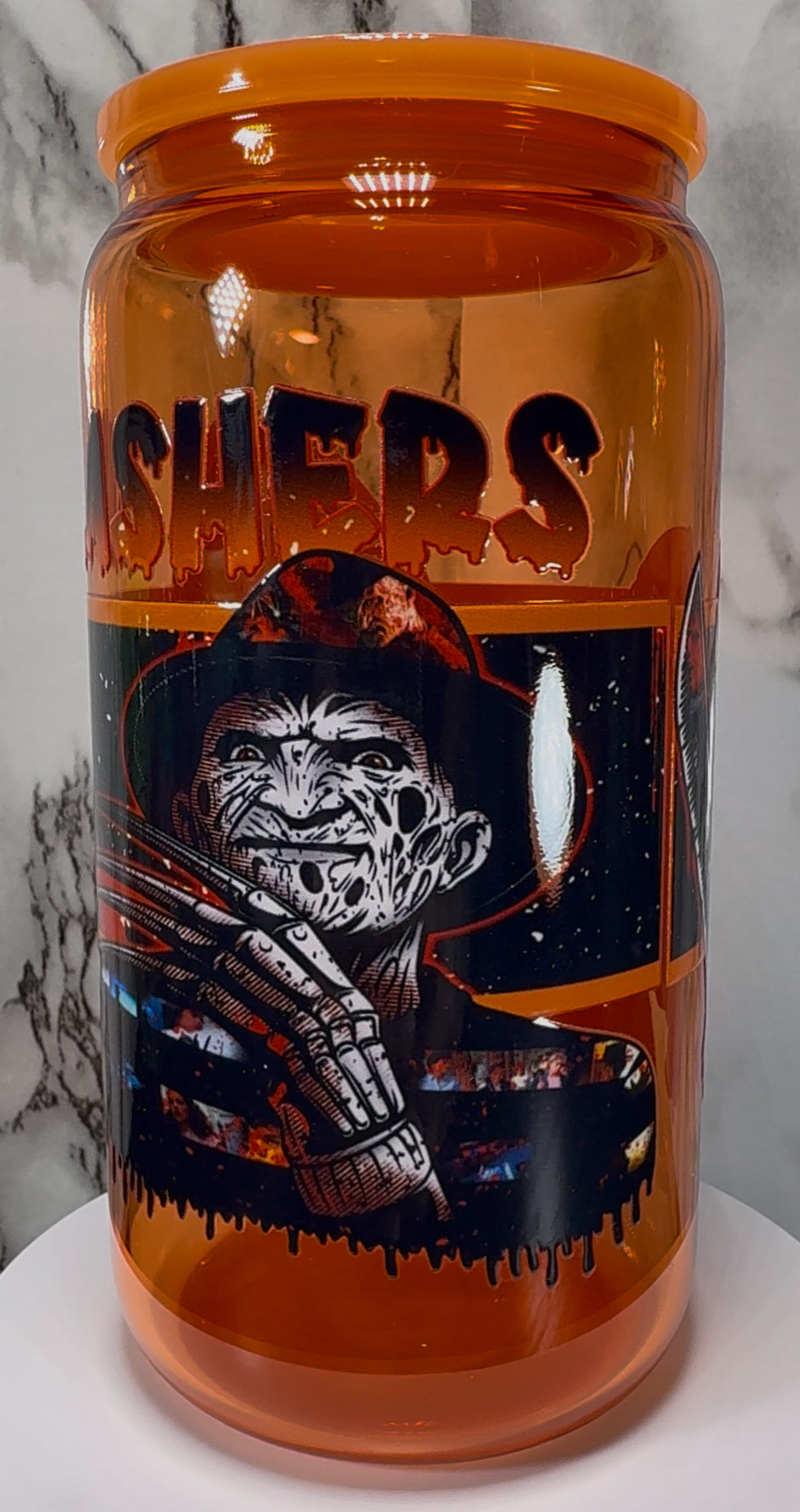 Slashers UVDTF on a orange beer can glass