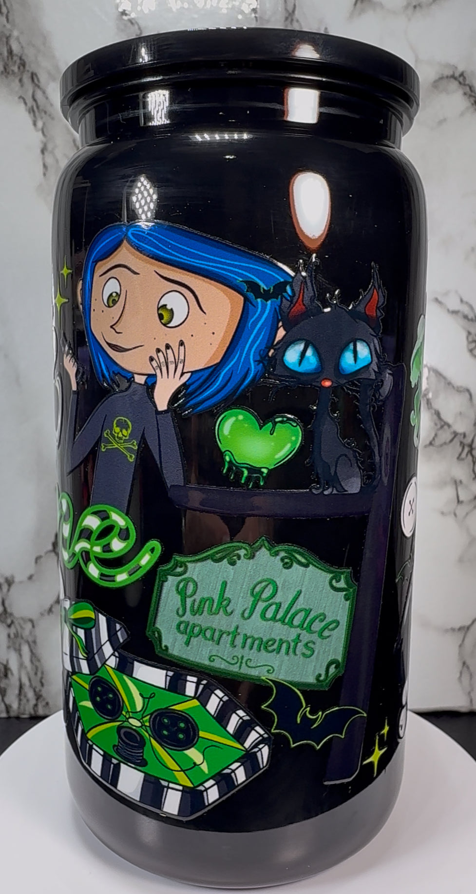 Coraline Green UVDTF on a black plastic beer can cup