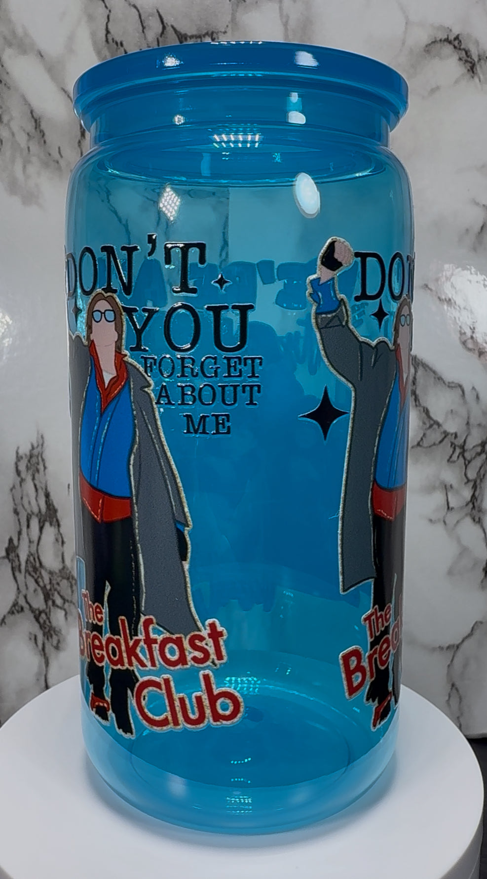 Breakfast Club UVDTF on a bright blue PLASTIC beer can cup