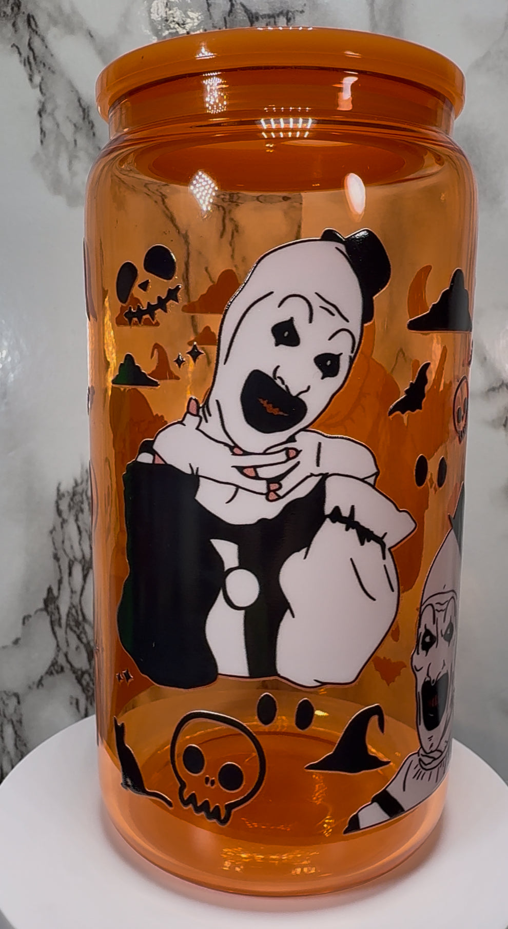 Art Terrifier UVDTF on a orange beer can glass