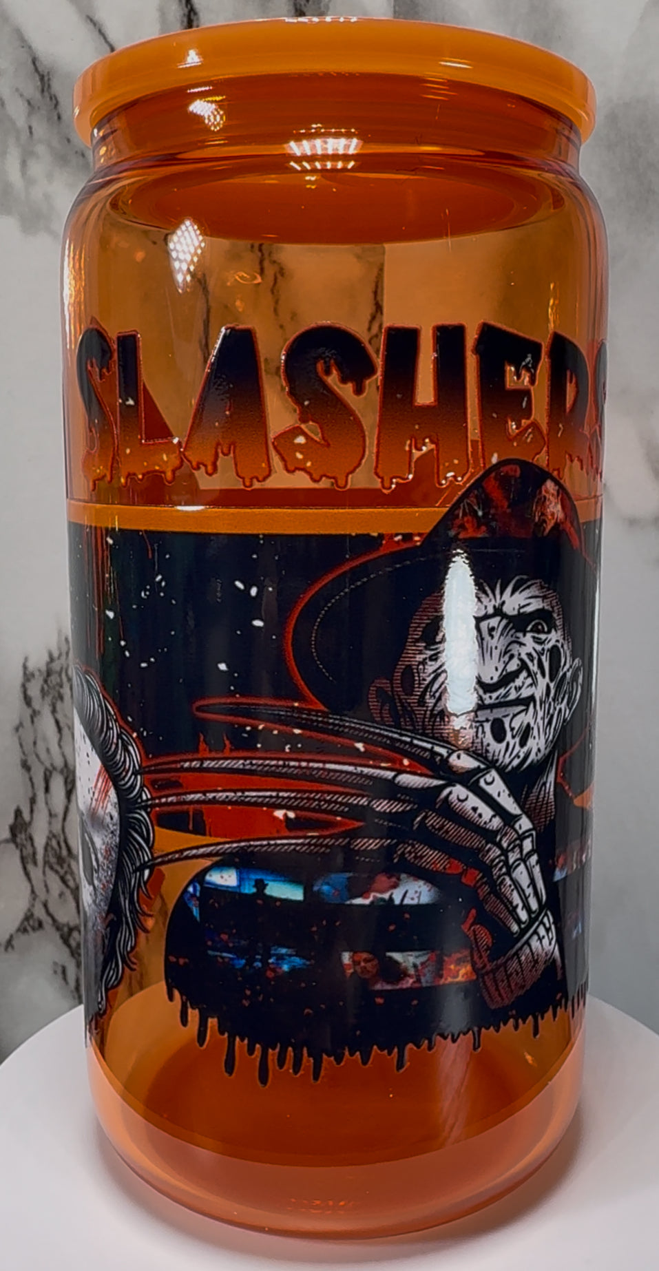 Slashers UVDTF on a orange beer can glass