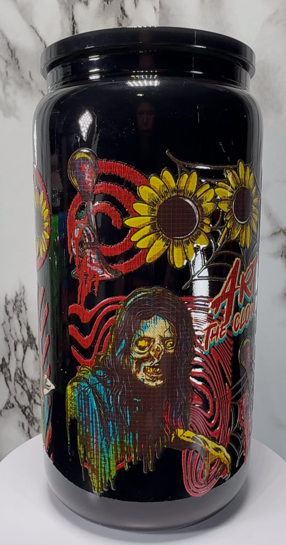 Terrifier Art The Clown UVDTF on a black beer can glass