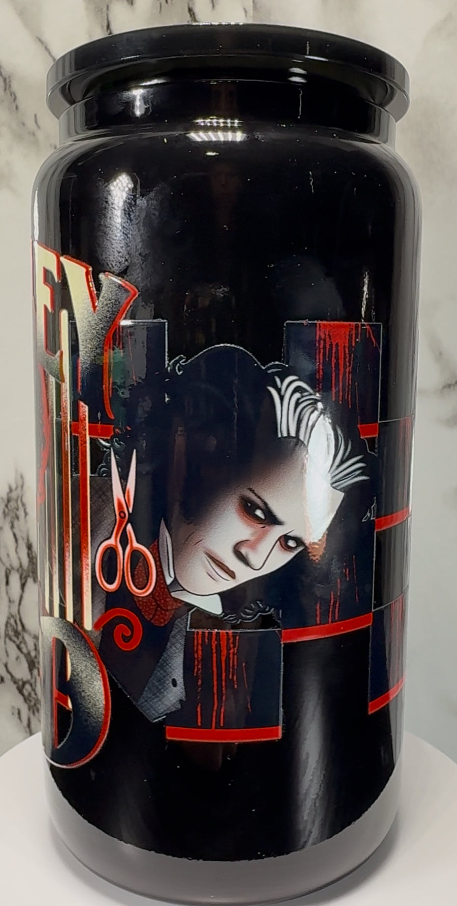 Sweeney Todd UVDTF on a black beer can glass