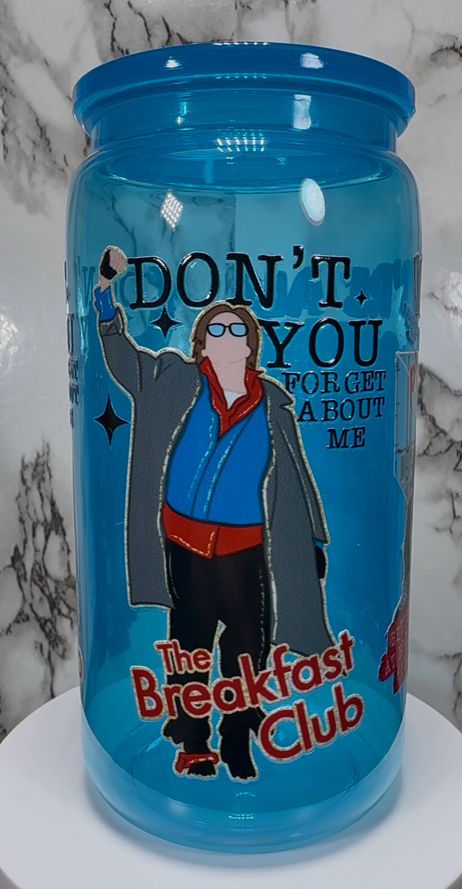 Breakfast Club UVDTF on a bright blue PLASTIC beer can cup
