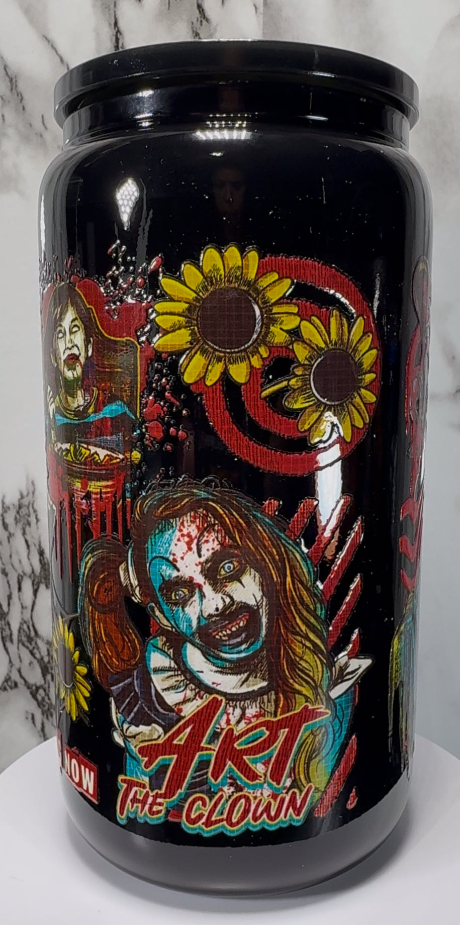 Terrifier Art The Clown UVDTF on a black beer can glass