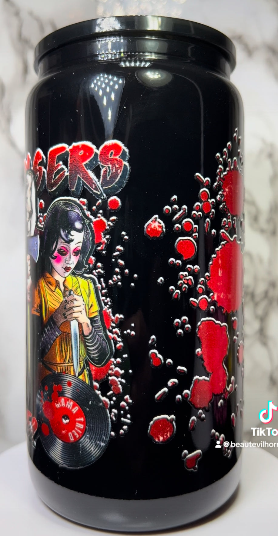 The Strangers UVDTF on a black beer can glass