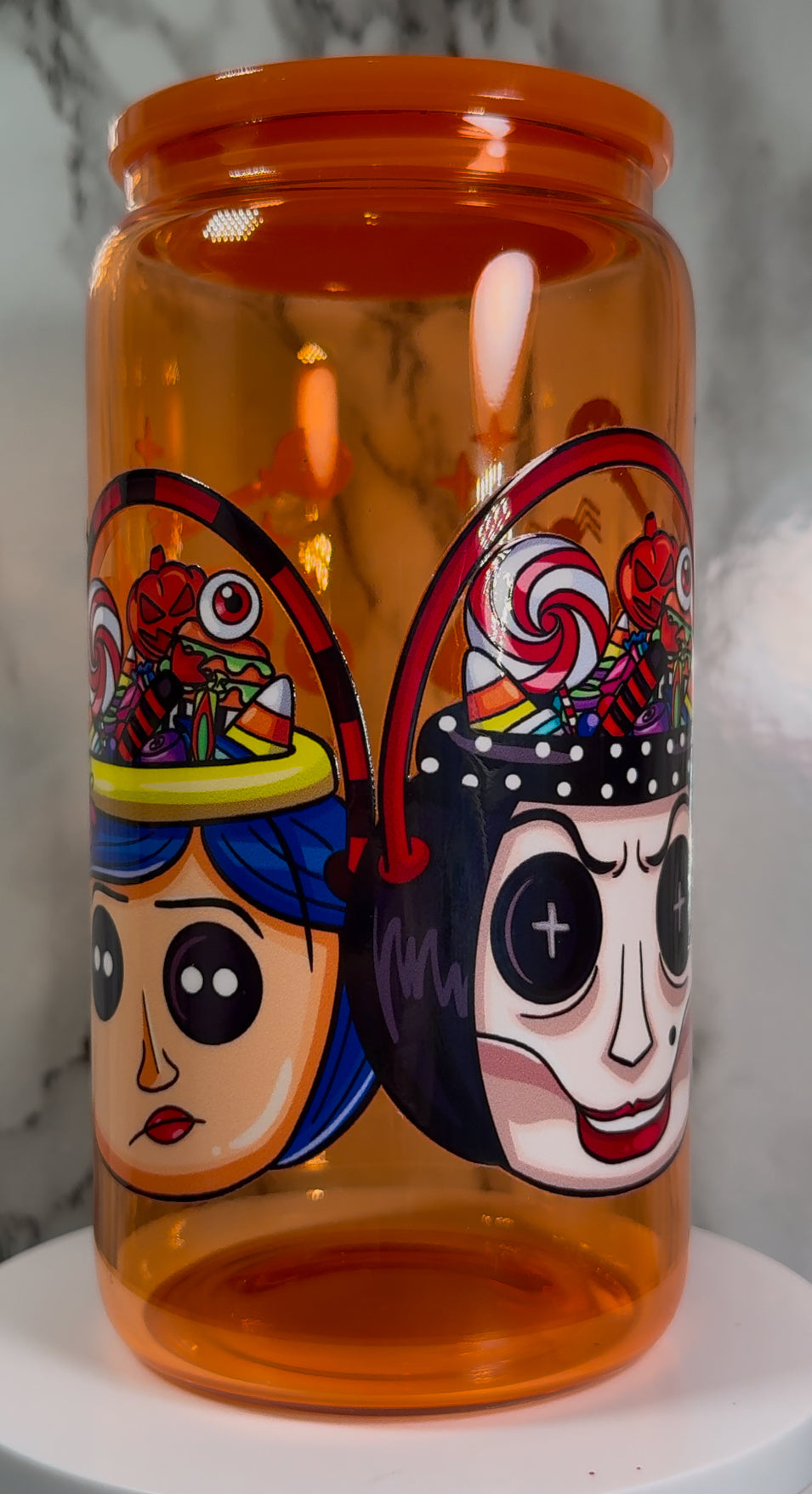 Coraline & Other Mother Halloween Candy Buckets UVDTF on a orange beer can glass