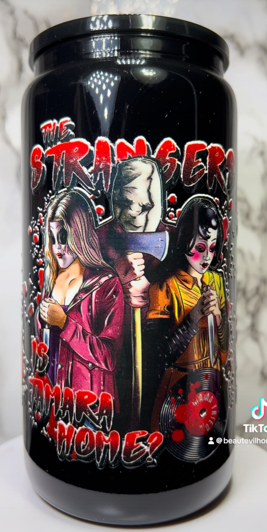 The Strangers UVDTF on a black beer can glass