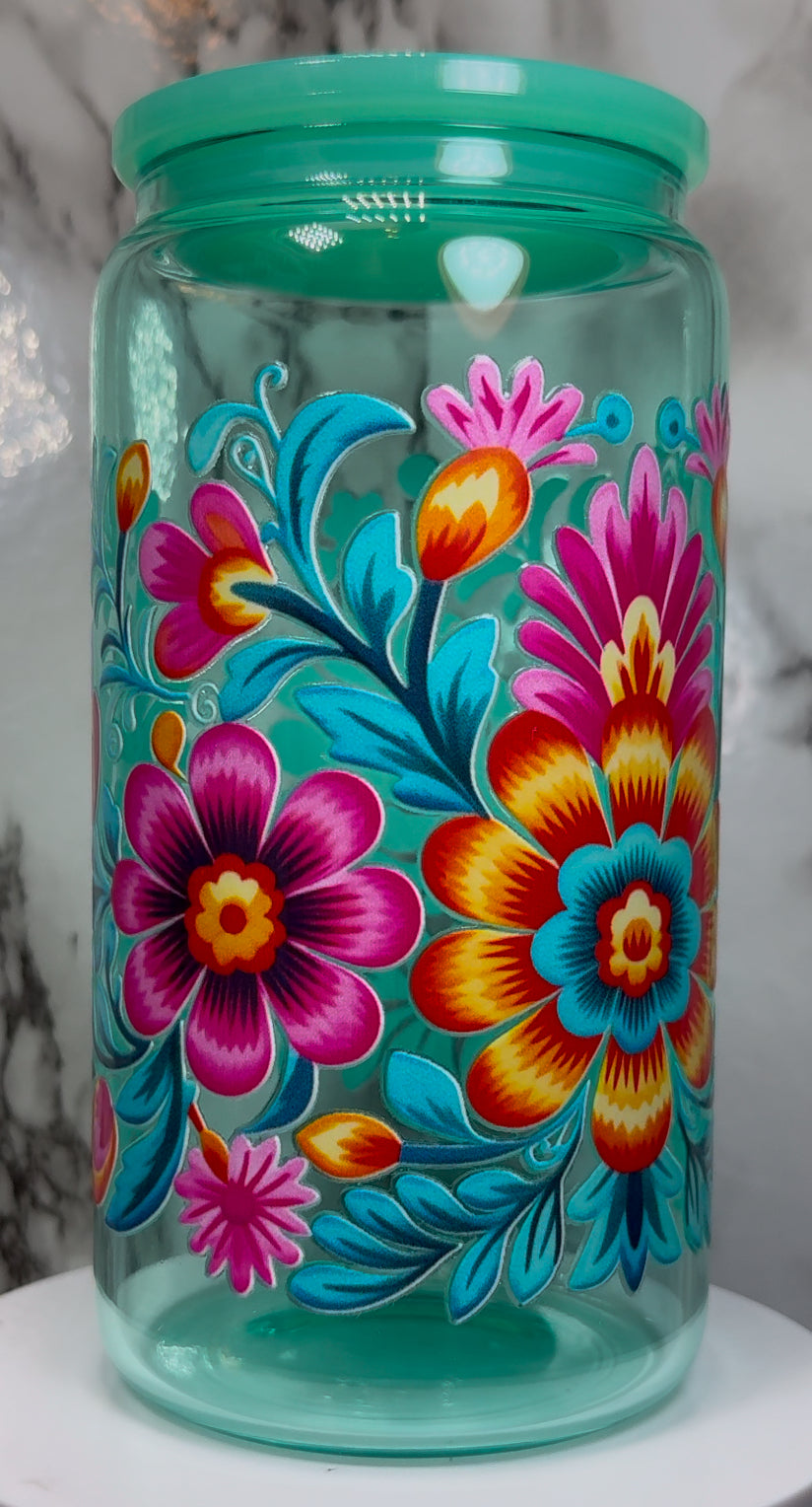 Floral UVDTF on a teal beer can glass