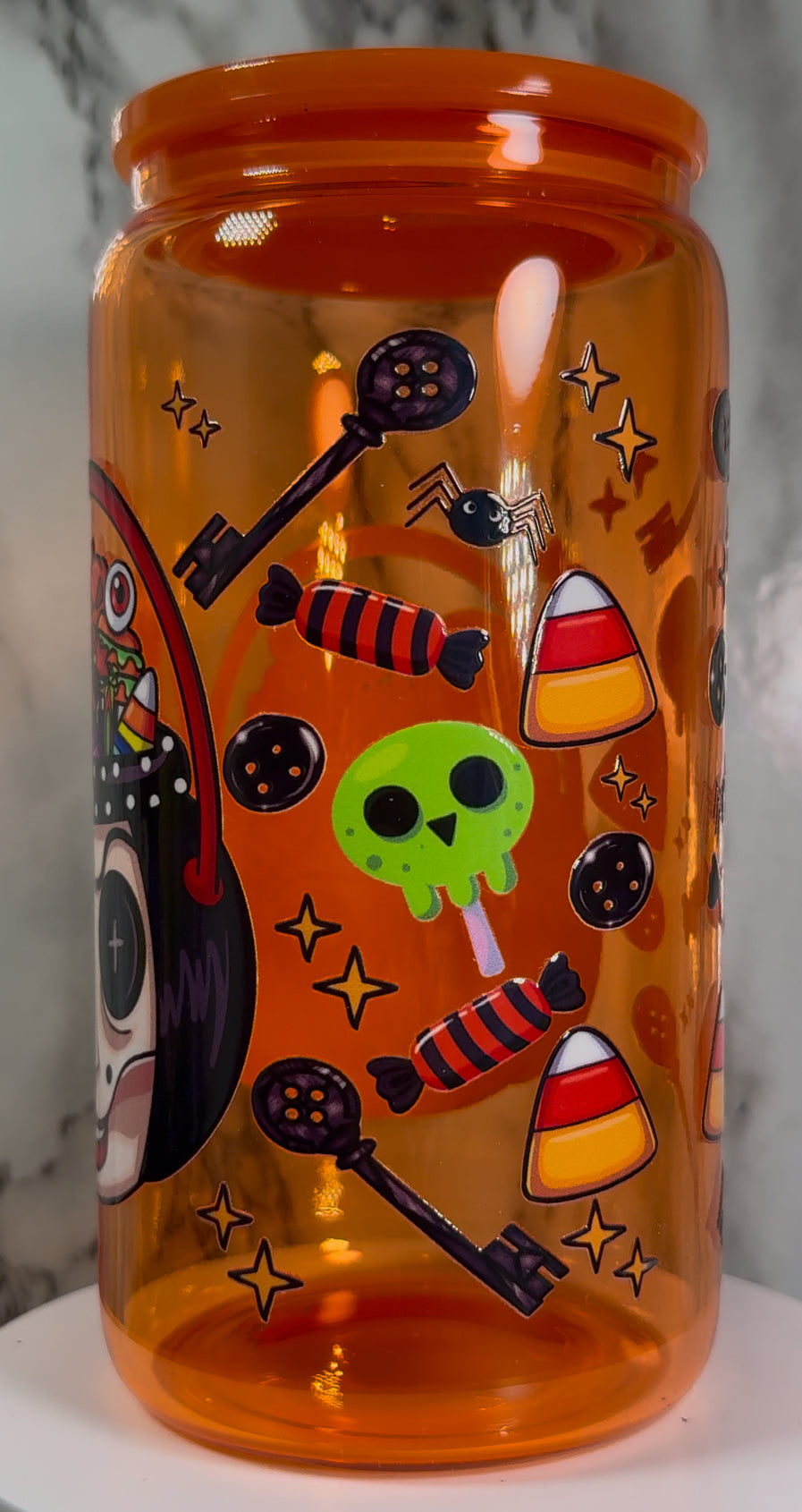 Coraline & Other Mother Halloween Candy Buckets UVDTF on a orange beer can glass