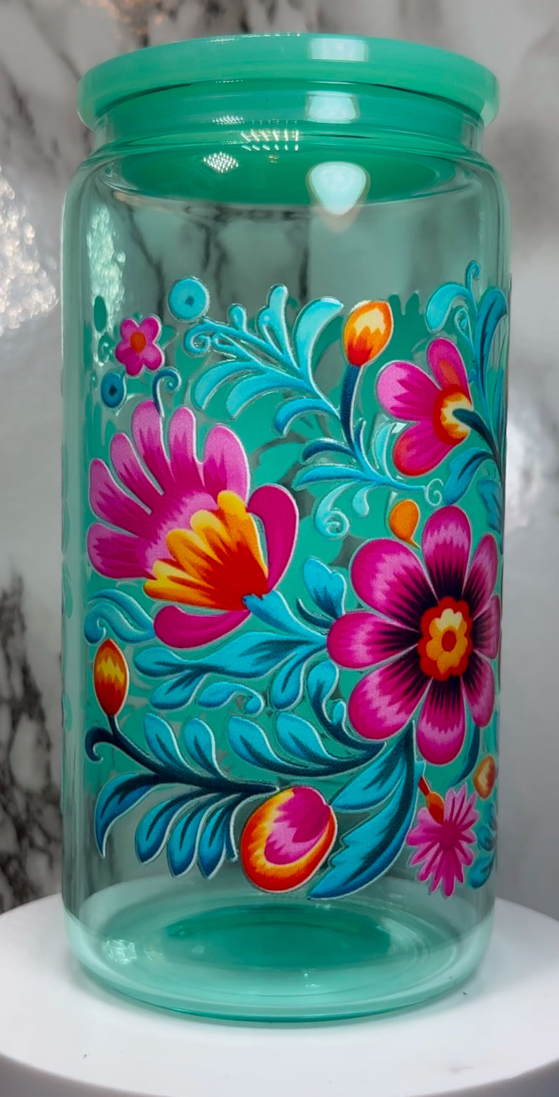 Floral UVDTF on a teal beer can glass