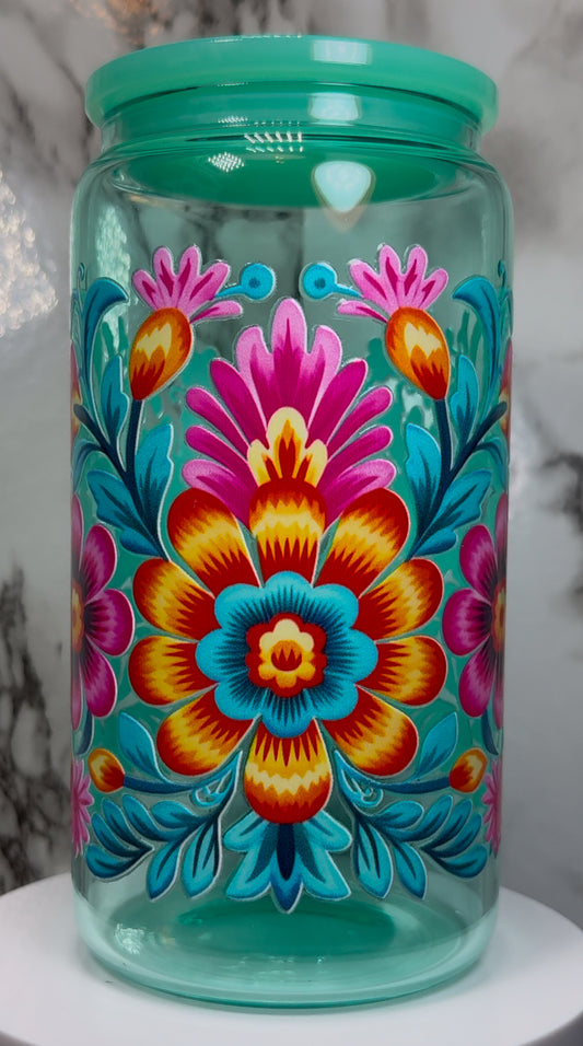 Floral UVDTF on a teal beer can glass