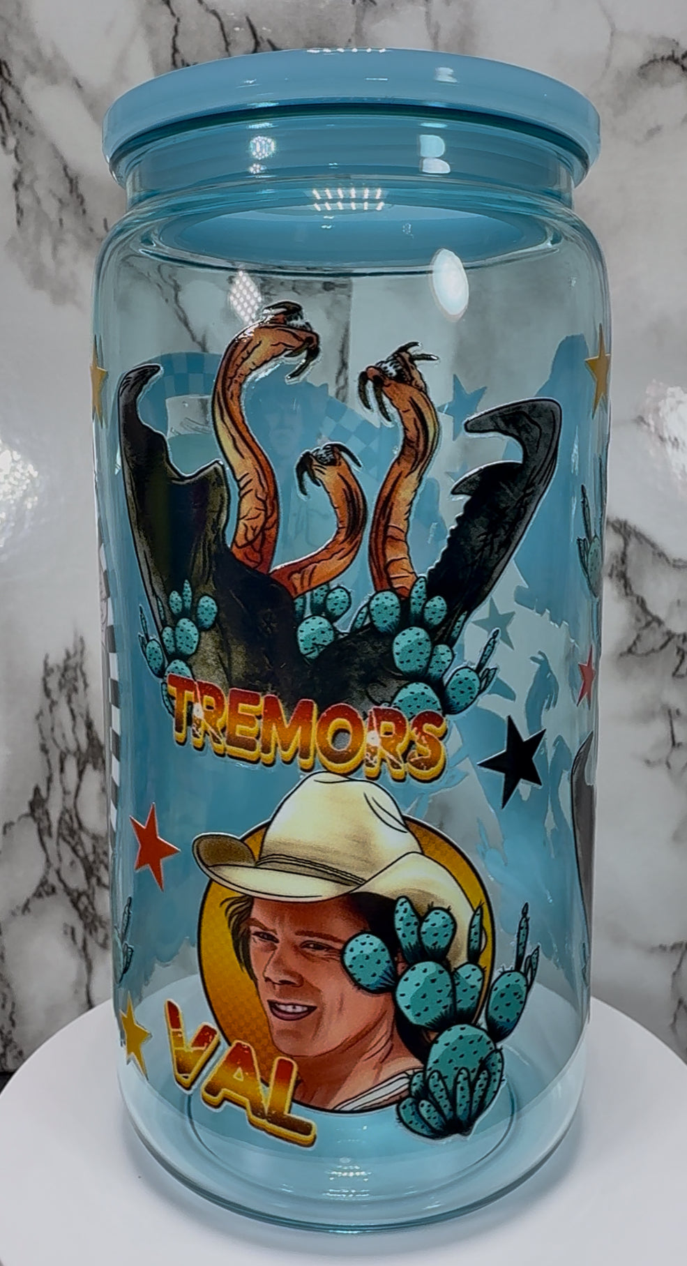 Tremors UVDTF on a light blue PLASTIC beer can cup