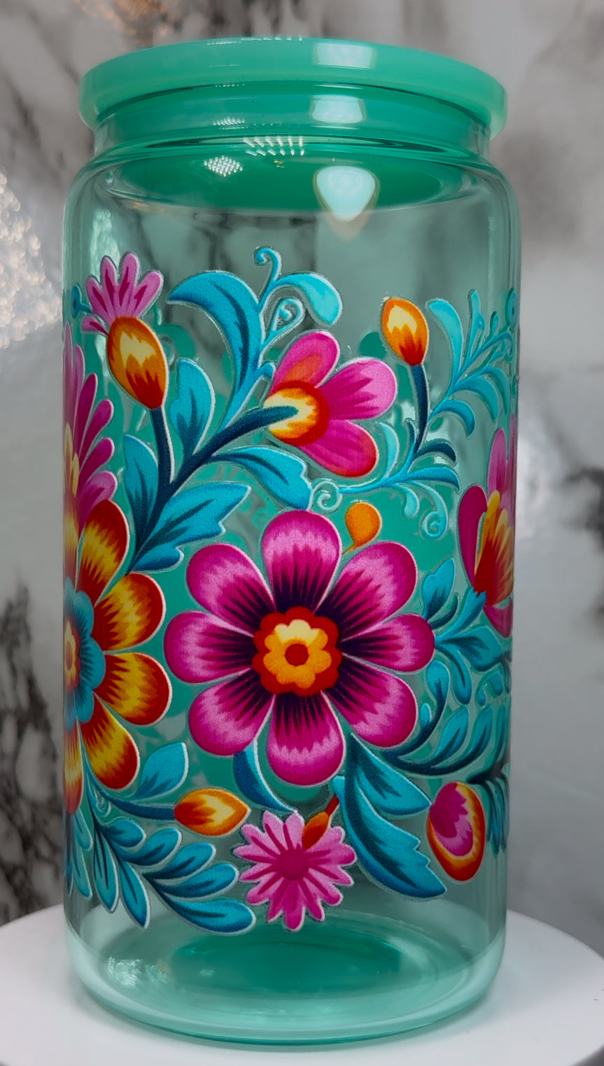 Floral UVDTF on a teal beer can glass