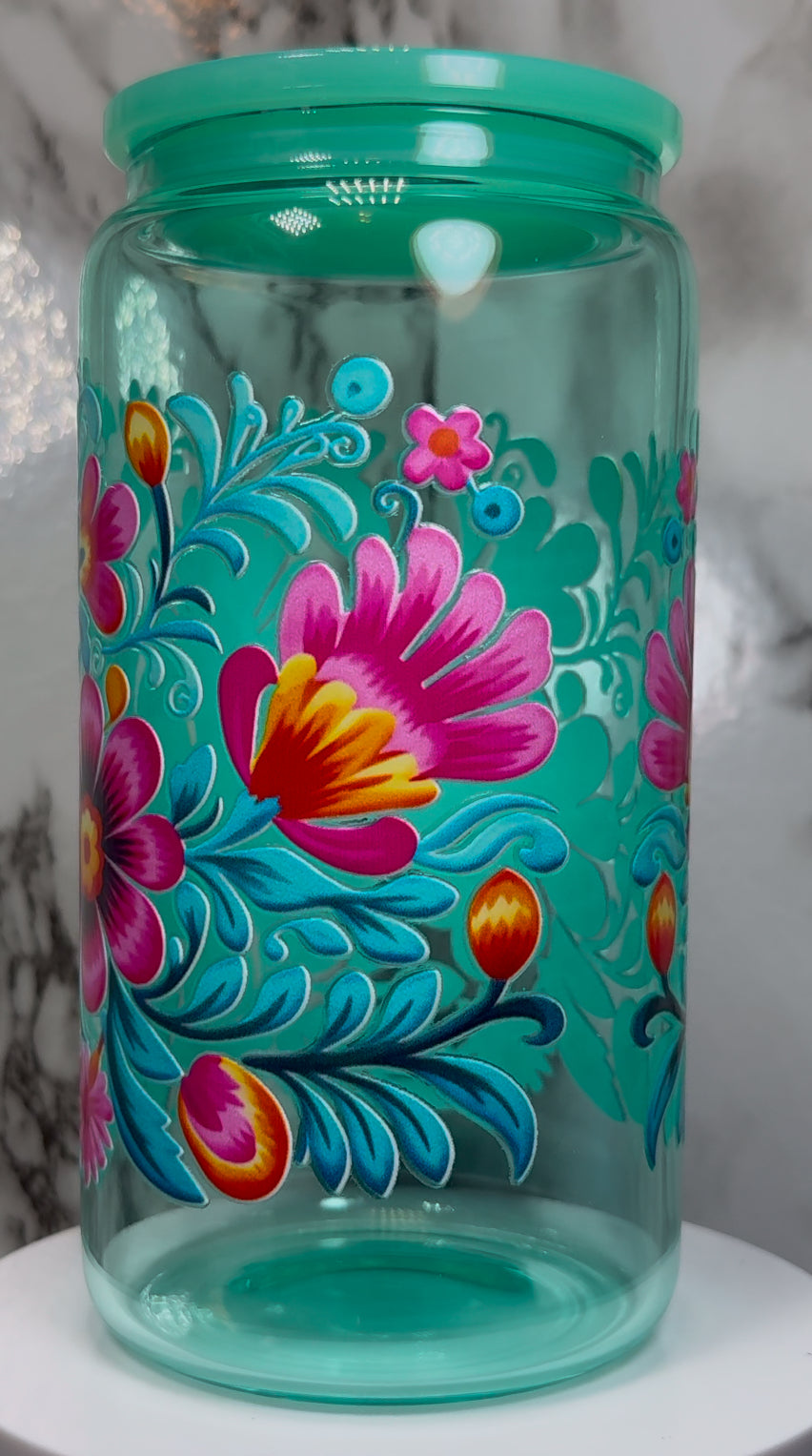 Floral UVDTF on a teal beer can glass