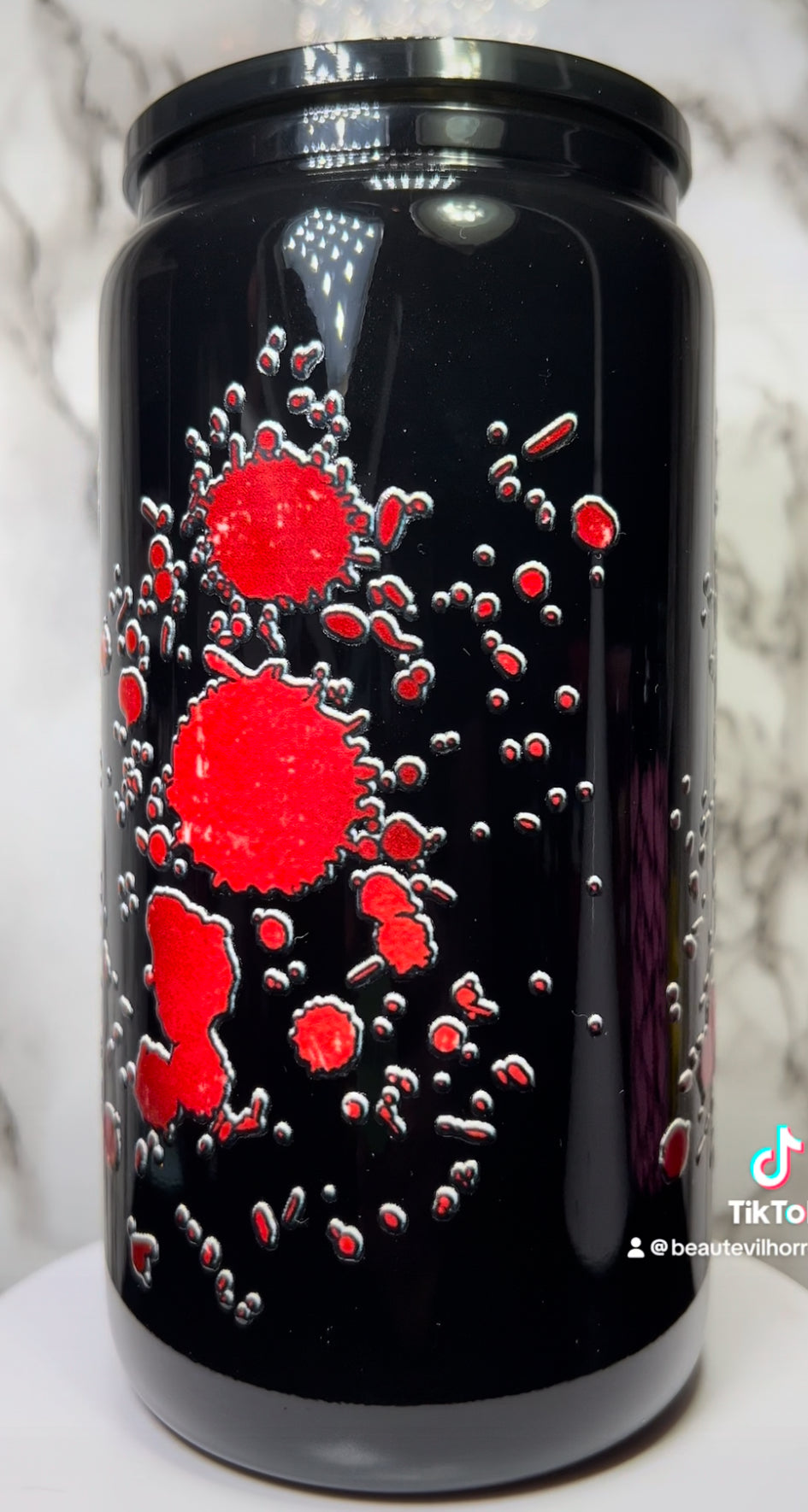 The Strangers UVDTF on a black beer can glass