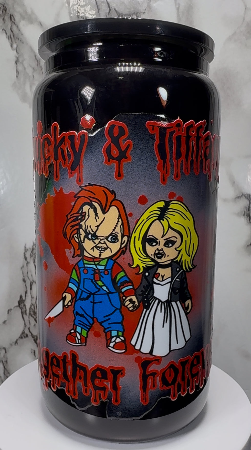 Chucky & Tiffany UVDTF on a black beer can glass