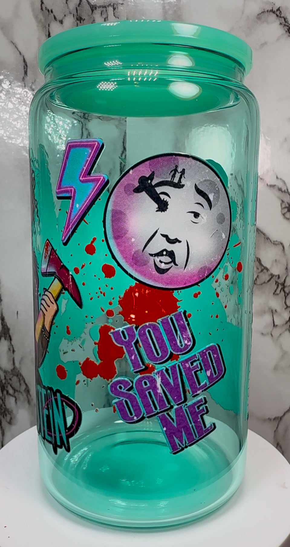 Lisa Frankenstein UVDTF on a teal beer can glass